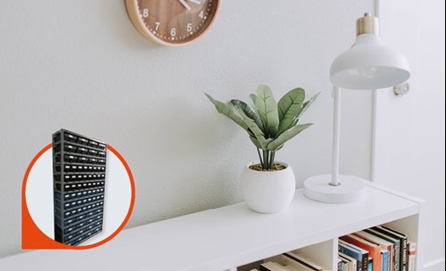 Home interior, book shelve with books, plant and lamp on top