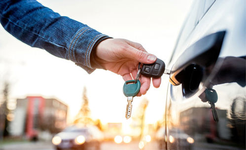 Person unlocking car with a key