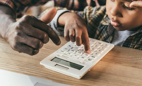 Father and son using a calculator