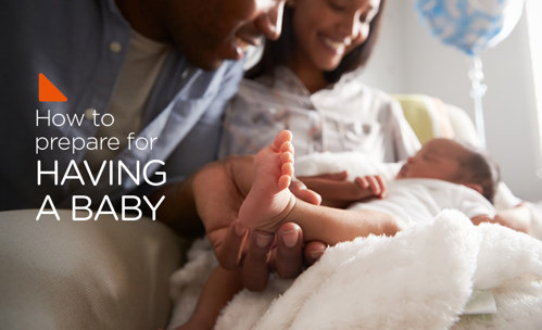 Parents smiling and holding new born