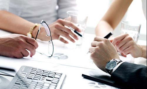 People in a meeting, sitting at a table